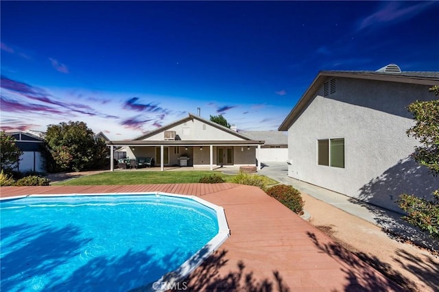 7434 Paisley Ave, Hesperia, CA 92345 - pool at dusk with a patio and a lawn