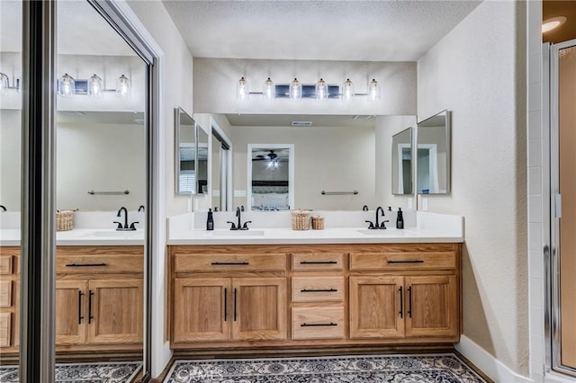 7434 Paisley Ave, Hesperia, CA 92345 - full bathroom featuring double vanity, a textured ceiling, and a ceiling fan