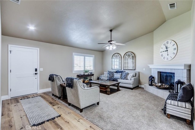 7434 Paisley Ave, Hesperia, CA 92345 - living area featuring vaulted ceiling, a ceiling fan, a tiled fireplace, and light wood-style floors