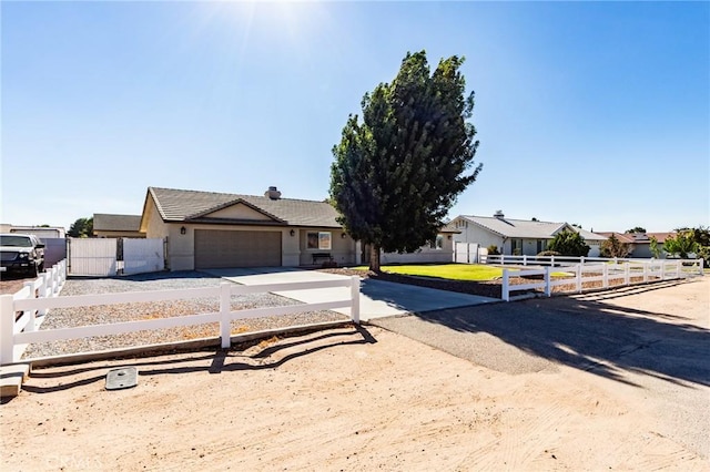 7434 Paisley Ave, Hesperia, CA 92345 - view of front of home featuring driveway, an attached garage, a tile roof, a chimney, and stucco siding