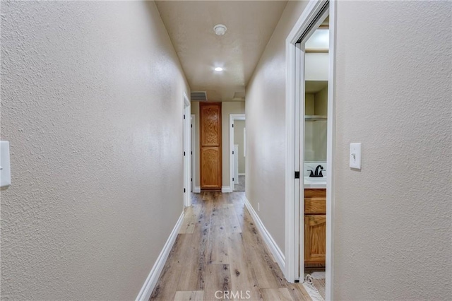 7434 Paisley Ave, Hesperia, CA 92345 - hall featuring light wood-style floors and a textured wall