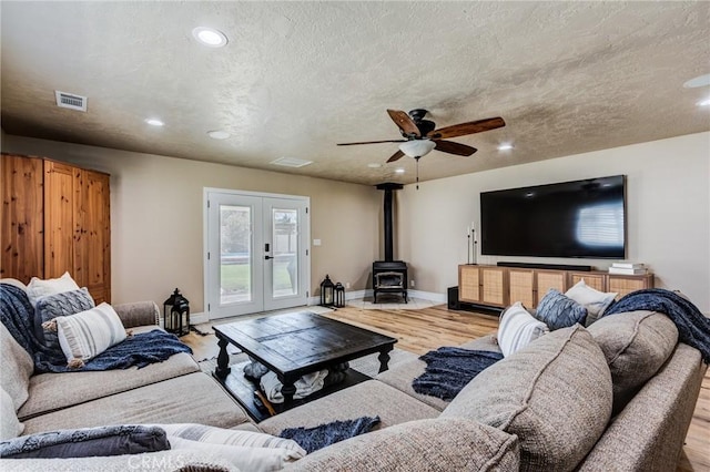 7434 Paisley Ave, Hesperia, CA 92345 - living area with a wood stove, wood finished floors, recessed lighting, ceiling fan, and french doors