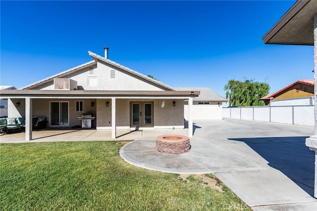 7434 Paisley Ave, Hesperia, CA 92345 - rear view of property featuring french doors, stucco siding, an outdoor fire pit, and a patio area