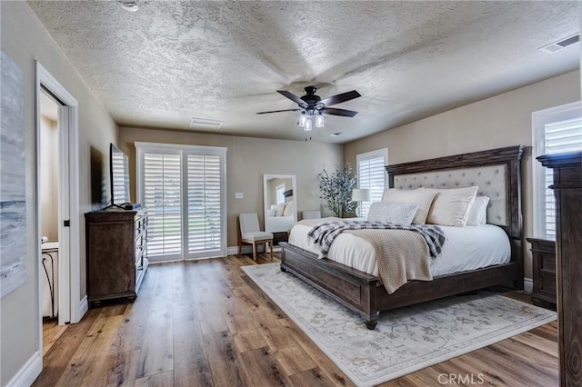 7434 Paisley Ave, Hesperia, CA 92345 - bedroom with wood finished floors, a textured ceiling, and a ceiling fan