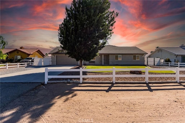 7434 Paisley Ave, Hesperia, CA 92345 - view of front of home with driveway, a fenced front yard, a garage, and a tile roof