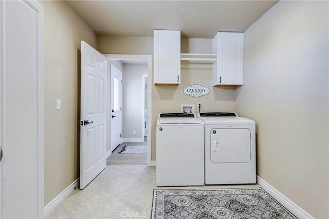 7434 Paisley Ave, Hesperia, CA 92345 - laundry room featuring separate washer and dryer, cabinet space, and light tile patterned floors
