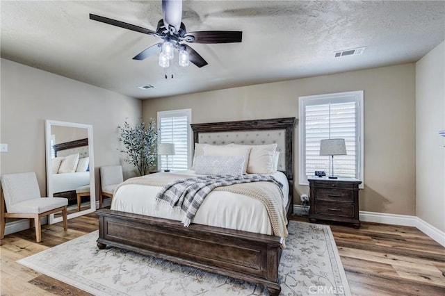 7434 Paisley Ave, Hesperia, CA 92345 - bedroom with wood finished floors, ceiling fan, and a textured ceiling