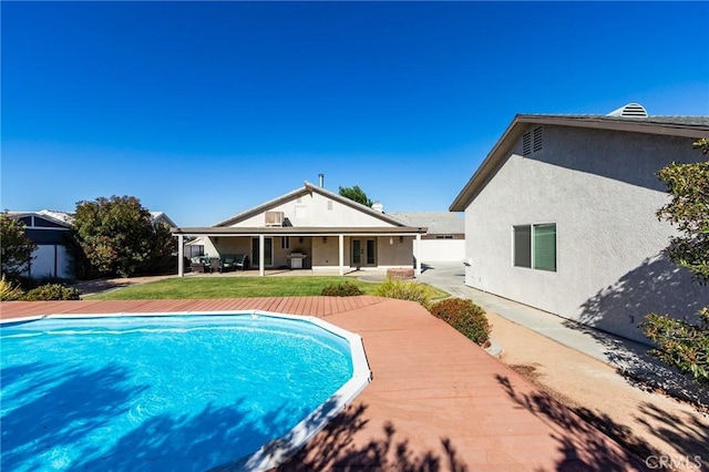 7434 Paisley Ave, Hesperia, CA 92345 - outdoor pool featuring french doors, a patio area, and a lawn