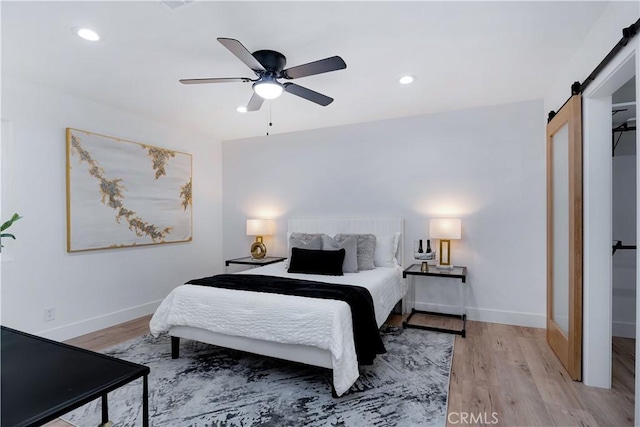 1061 Colby Cir, Thousand Oaks, CA 91362 - bedroom with a barn door, light wood-style flooring, recessed lighting, and ceiling fan