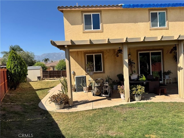 1465 Ardith Ct, Beaumont, CA 92223 - back of property featuring a fenced backyard, a storage shed, stucco siding, and a patio area