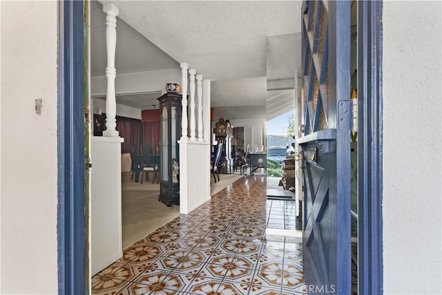 16401 Gothic Pl, Granada Hills, CA 91344 - hallway featuring a textured ceiling and tile patterned floors