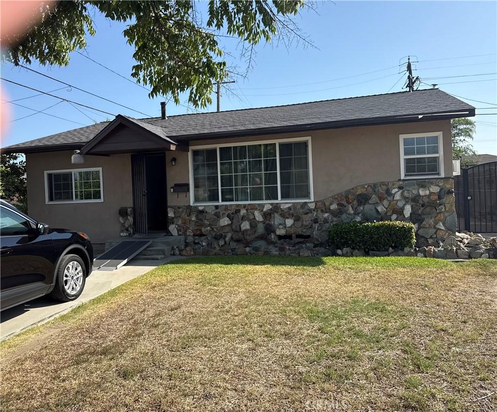 6156 Mckinley Ave, South Gate, CA 90280 - single story home with stucco siding, stone siding, a front lawn, and roof with shingles