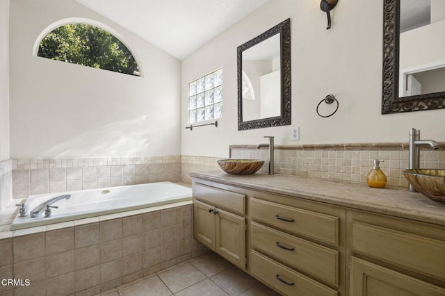 7748 Paso Robles St, Ventura, CA 93004 - bathroom with vaulted ceiling, a bath, vanity, and tile patterned floors