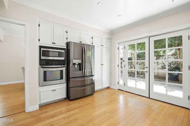 7748 Paso Robles St, Ventura, CA 93004 - kitchen featuring stainless steel appliances, crown molding, white cabinets, and light wood-type flooring