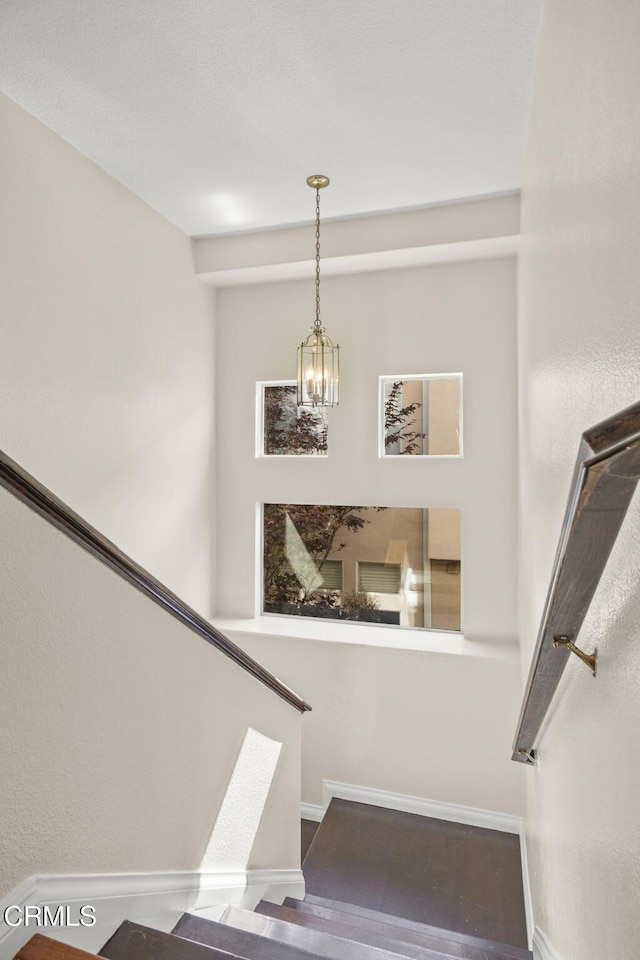 7748 Paso Robles St, Ventura, CA 93004 - staircase with a chandelier and wood finished floors