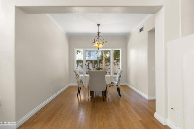 7748 Paso Robles St, Ventura, CA 93004 - dining room with hardwood / wood-style floors, ornamental molding, and a chandelier
