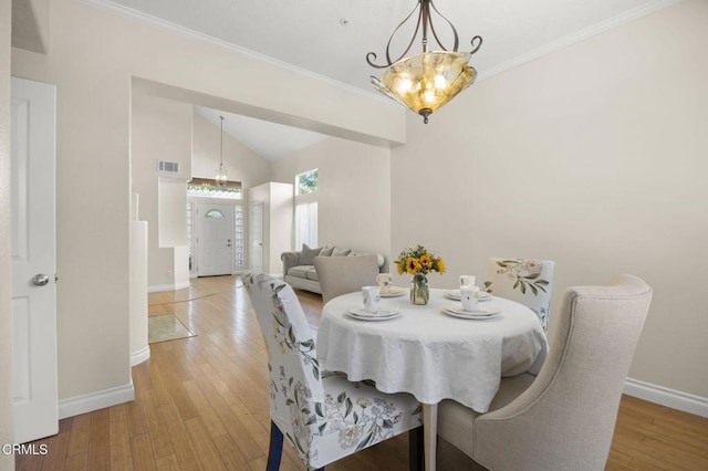 7748 Paso Robles St, Ventura, CA 93004 - dining space featuring a chandelier, light wood finished floors, vaulted ceiling, and crown molding