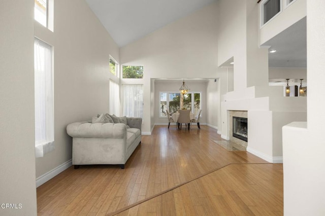 7748 Paso Robles St, Ventura, CA 93004 - living area with a towering ceiling, hardwood / wood-style flooring, a high end fireplace, and a chandelier