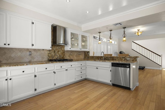 7748 Paso Robles St, Ventura, CA 93004 - kitchen with stainless steel dishwasher, wall chimney exhaust hood, a peninsula, white cabinetry, and tasteful backsplash