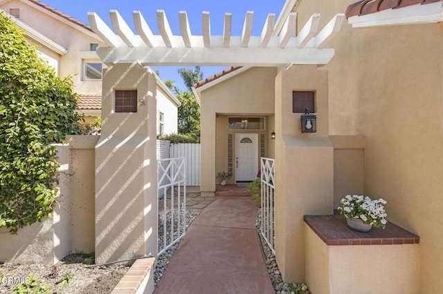 7748 Paso Robles St, Ventura, CA 93004 - view of exterior entry featuring a gate, stucco siding, and a tiled roof