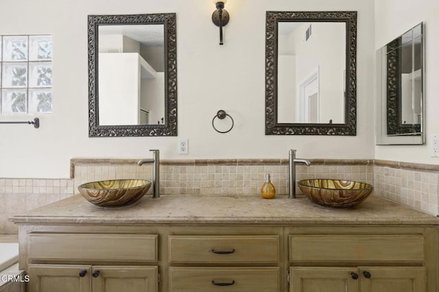 7748 Paso Robles St, Ventura, CA 93004 - bathroom featuring decorative backsplash, double vanity, and a tub