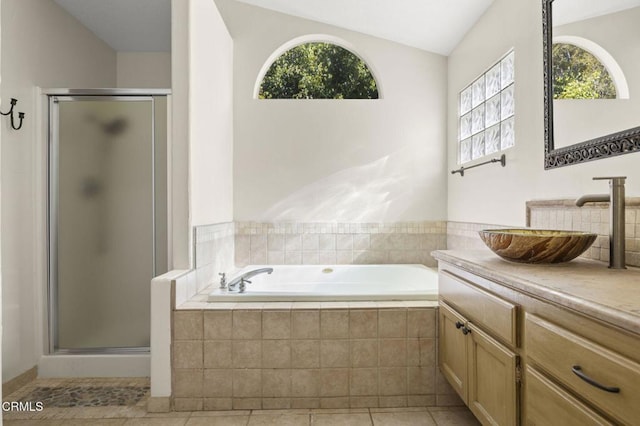 7748 Paso Robles St, Ventura, CA 93004 - bathroom with vanity, a shower stall, a bath, healthy amount of natural light, and vaulted ceiling