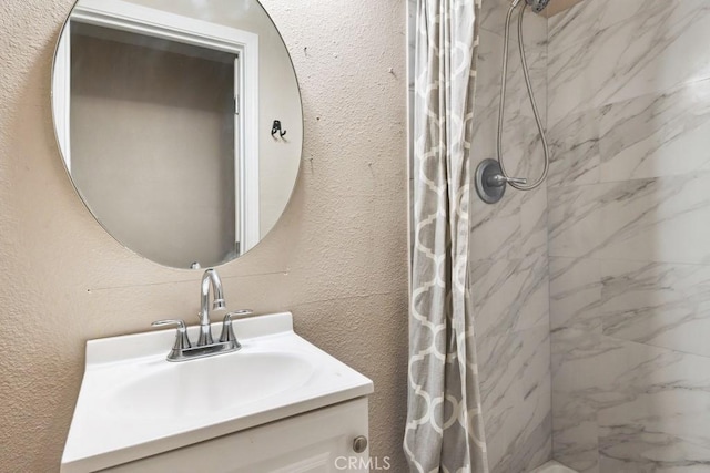 15722 Inyo St, Victorville, CA 92395 - bathroom featuring a marble finish shower, vanity, and a textured wall
