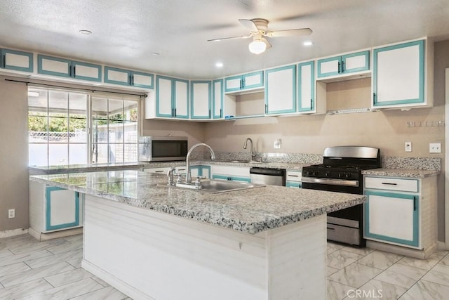 15722 Inyo St, Victorville, CA 92395 - kitchen featuring appliances with stainless steel finishes, light marble finish flooring, a ceiling fan, light stone countertops, and recessed lighting