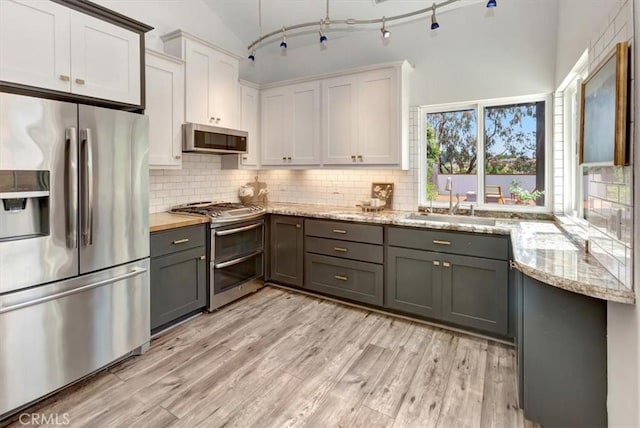 3010 Rosalinda Unit 50, San Clemente, CA 92673 - kitchen featuring appliances with stainless steel finishes, tasteful backsplash, white cabinetry, light wood-style floors, and gray cabinetry