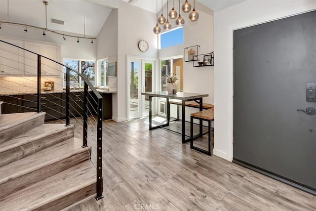 3010 Rosalinda Unit 50, San Clemente, CA 92673 - entryway with light wood-type flooring, high vaulted ceiling, stairway, and french doors