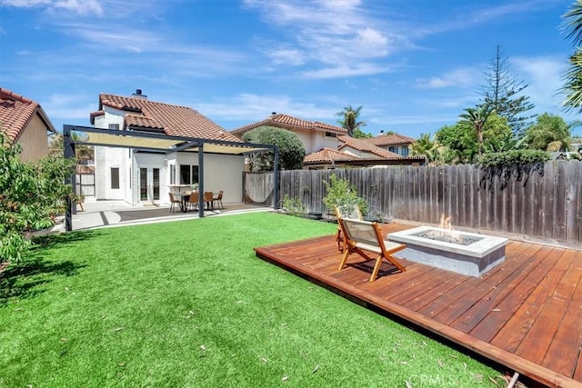 3010 Rosalinda Unit 50, San Clemente, CA 92673 - back of property featuring an outdoor fire pit, a wooden deck, french doors, and a fenced backyard