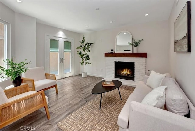 3010 Rosalinda Unit 50, San Clemente, CA 92673 - living room featuring french doors, wood finished floors, a brick fireplace, and recessed lighting