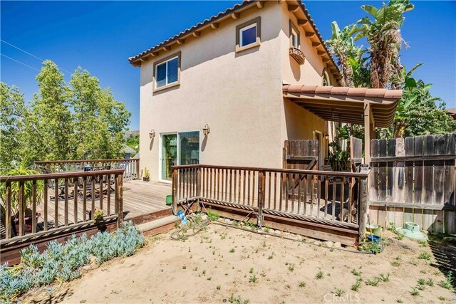 21460 Arapahoe Trl, Chatsworth, CA 91311 - rear view of house with stucco siding and a wooden deck