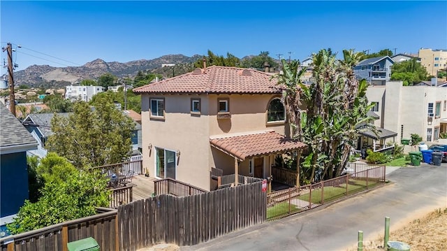 21460 Arapahoe Trl, Chatsworth, CA 91311 - view of home's exterior featuring stucco siding, a tiled roof, and a mountain view