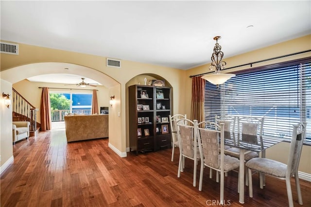 21460 Arapahoe Trl, Chatsworth, CA 91311 - dining area featuring arched walkways, wood finished floors, ceiling fan, and stairway