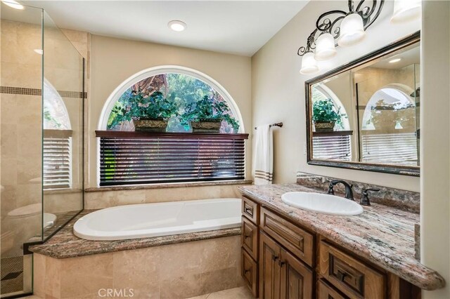 21460 Arapahoe Trl, Chatsworth, CA 91311 - bathroom with a shower stall, a bath, and vanity