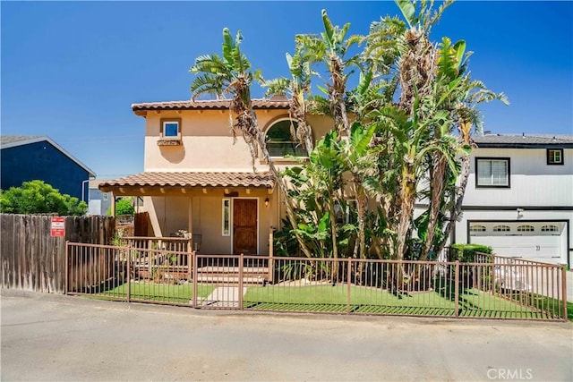 21460 Arapahoe Trl, Chatsworth, CA 91311 - view of front facade featuring stucco siding, a fenced front yard, an attached garage, and a tile roof