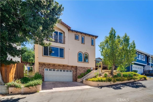 21460 Arapahoe Trl, Chatsworth, CA 91311 - view of front of home with a garage, stucco siding, a balcony, and driveway
