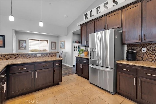 9512 Mesquite St, Phelan, CA 92371 - kitchen with stainless steel fridge with ice dispenser, backsplash, vaulted ceiling, dark brown cabinets, and decorative light fixtures