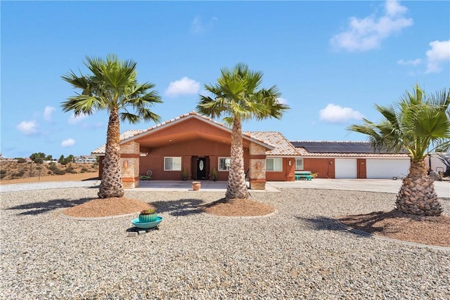 9512 Mesquite St, Phelan, CA 92371 - ranch-style home with a tile roof, roof mounted solar panels, stucco siding, and driveway