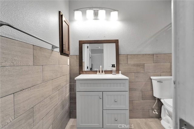 9512 Mesquite St, Phelan, CA 92371 - half bathroom with vanity, tile walls, and wainscoting