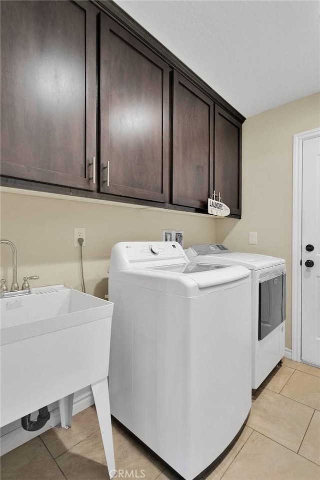 9512 Mesquite St, Phelan, CA 92371 - laundry area with washer and dryer, light tile patterned flooring, and cabinet space