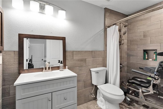 9512 Mesquite St, Phelan, CA 92371 - full bathroom featuring tile walls, vanity, a tile shower, and a wainscoted wall