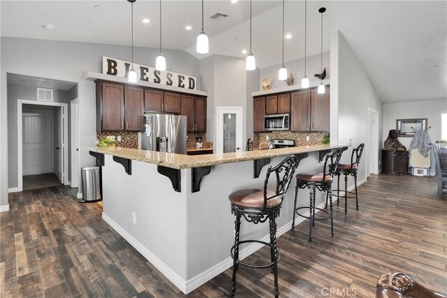 9512 Mesquite St, Phelan, CA 92371 - kitchen featuring stainless steel appliances, tasteful backsplash, dark wood-style floors, high vaulted ceiling, and a breakfast bar
