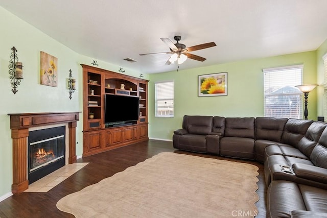27597 Lafayette Way, Moreno Valley, CA 92555 - living room featuring a ceiling fan, healthy amount of natural light, a fireplace with flush hearth, and dark wood finished floors