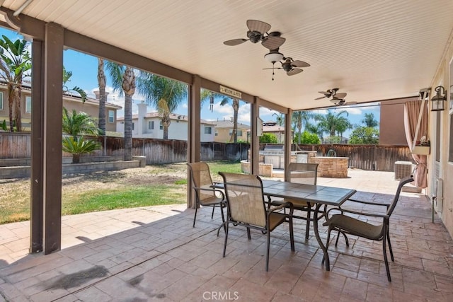 27597 Lafayette Way, Moreno Valley, CA 92555 - fenced backyard with exterior kitchen, a patio, outdoor dining space, a ceiling fan, and a residential view