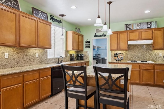 27597 Lafayette Way, Moreno Valley, CA 92555 - kitchen with under cabinet range hood, washing machine and clothes dryer, light tile patterned floors, black dishwasher, and recessed lighting