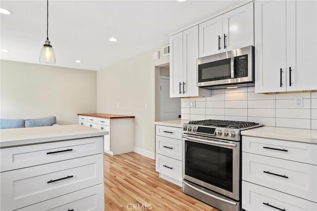 3420 Marna Ave, Long Beach, CA 90808 - kitchen featuring stainless steel appliances, decorative backsplash, light wood-style floors, light countertops, and recessed lighting