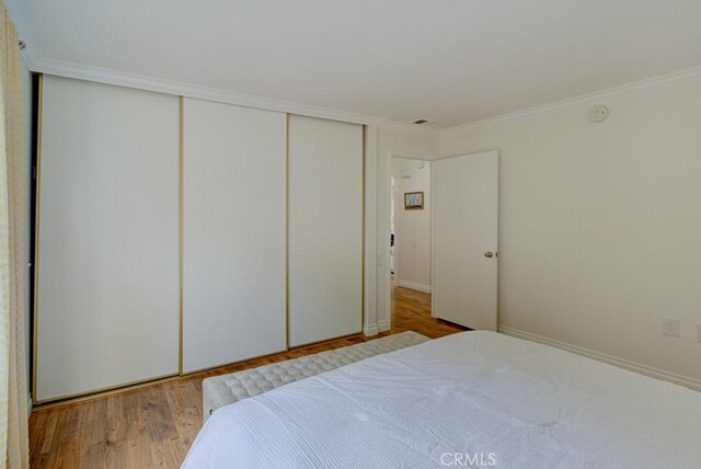 3130 Via Serena N Unit B, Laguna Woods, CA 92637 - bedroom featuring wood finished floors, a closet, and ornamental molding
