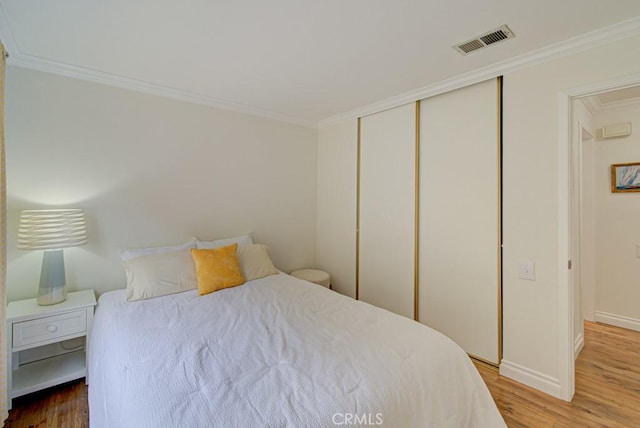 3130 Via Serena N Unit B, Laguna Woods, CA 92637 - bedroom featuring wood finished floors, crown molding, and a closet